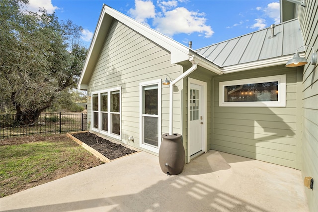 view of exterior entry with a patio area