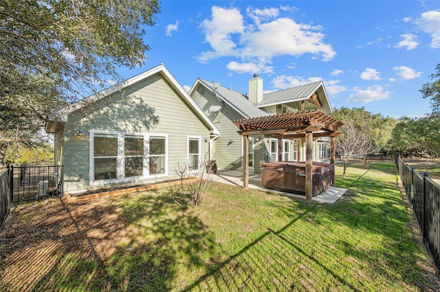 back of house featuring a yard, a pergola, a patio area, and a hot tub