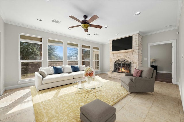 living room with crown molding, light tile patterned floors, ceiling fan, and a fireplace