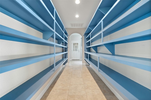 hall with tile patterned floors