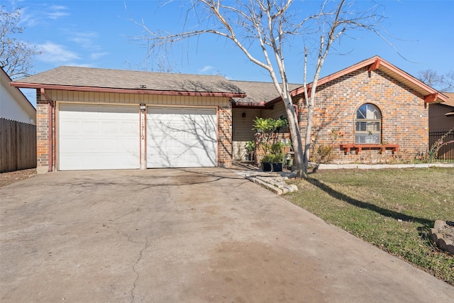 ranch-style house featuring a front yard and a garage