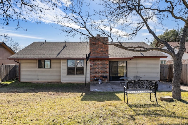 rear view of house featuring a patio area and a yard