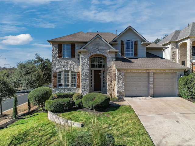 view of front of property featuring a garage and a front yard