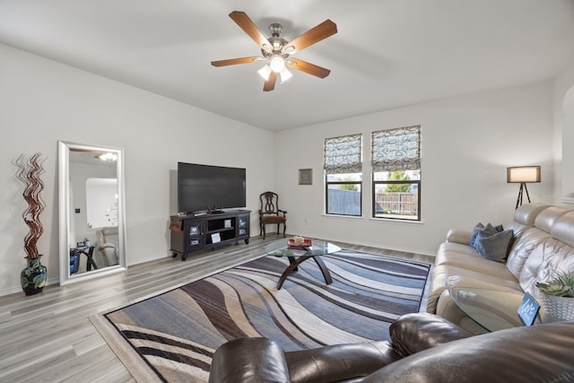 living room featuring light wood-type flooring and ceiling fan