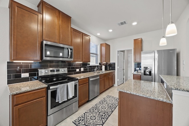 17106 Gibbons Path, Round Rock, TX 78664 - kitchen with appliances with stainless steel finishes, tasteful backsplash, a sink, light tile patterned flooring, and light stone counters