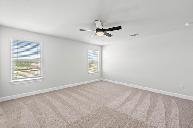 spare room featuring carpet flooring and ceiling fan