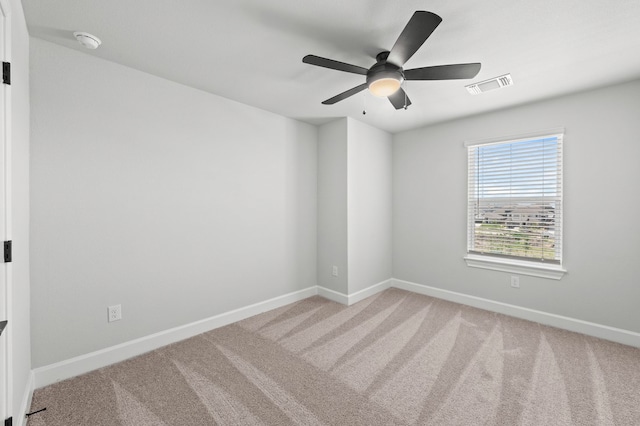 carpeted spare room featuring ceiling fan