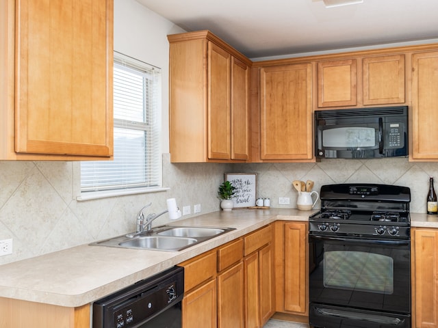 kitchen featuring sink, black appliances, and tasteful backsplash