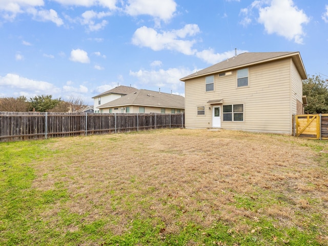 rear view of house with a lawn