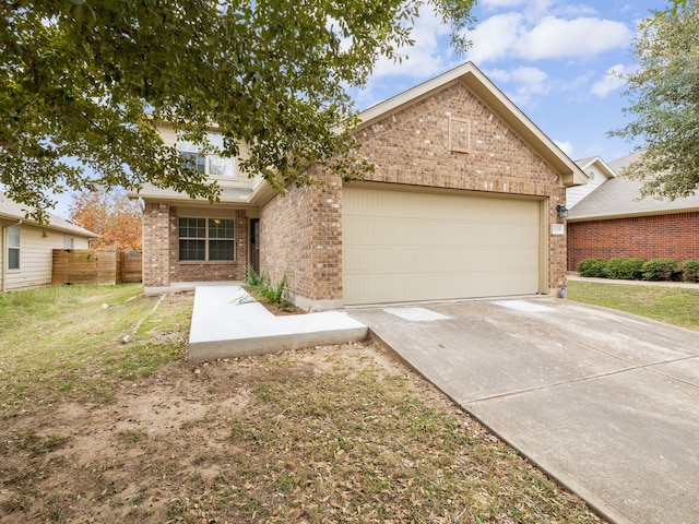 view of front of property featuring a garage and a front lawn