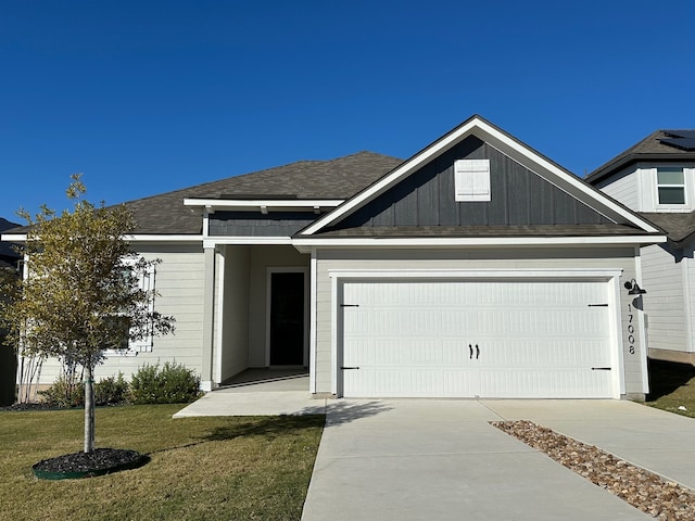 view of front of home with a garage and a front yard