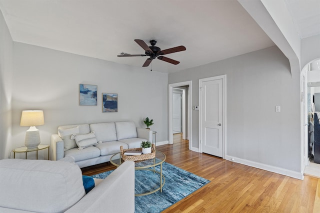 living room featuring ceiling fan and hardwood / wood-style floors