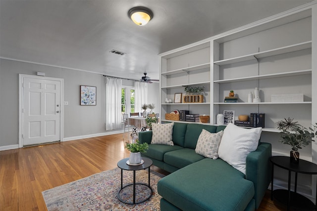 living room with hardwood / wood-style flooring and ceiling fan