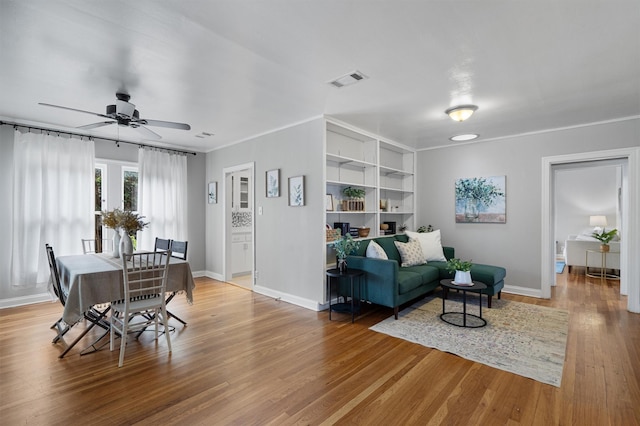 living room featuring light hardwood / wood-style floors and ceiling fan