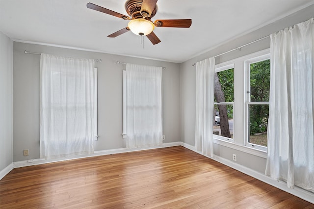 empty room featuring ceiling fan and light hardwood / wood-style flooring