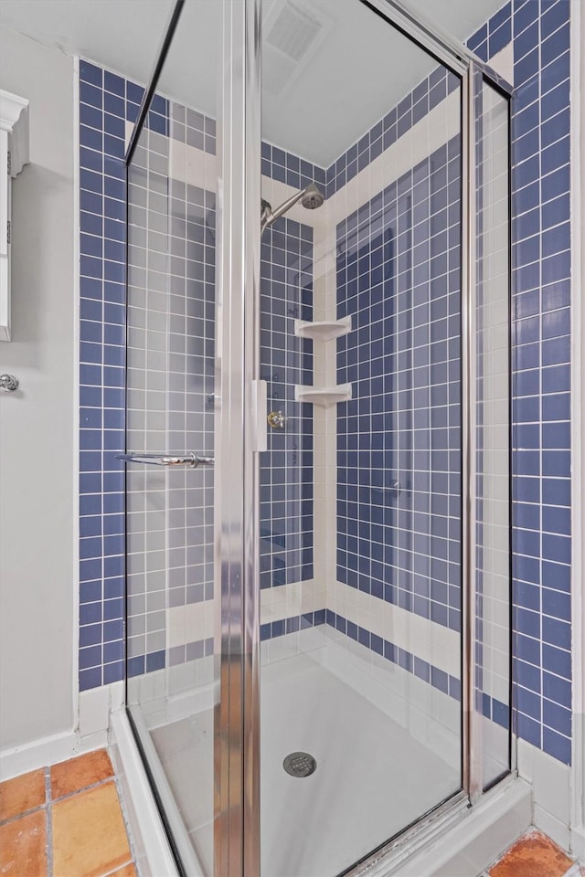 bathroom with tile patterned floors and an enclosed shower