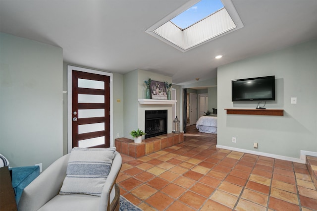 living room with tile patterned floors and a tiled fireplace