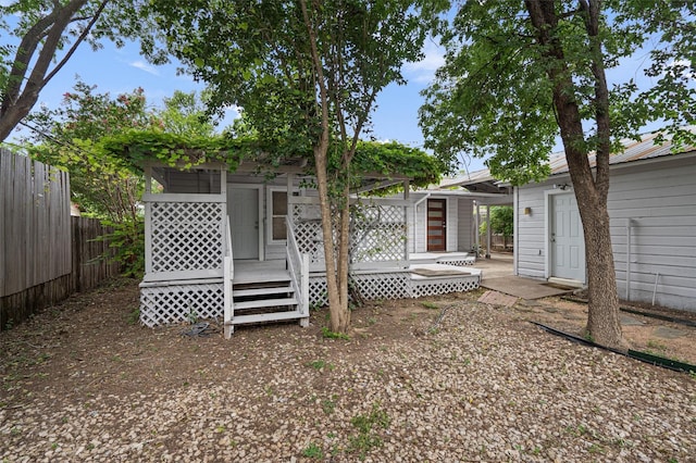 back of property featuring a wooden deck