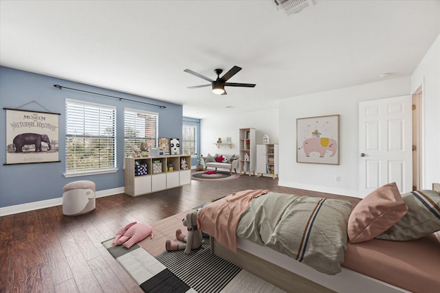 bedroom with ceiling fan and dark wood-type flooring