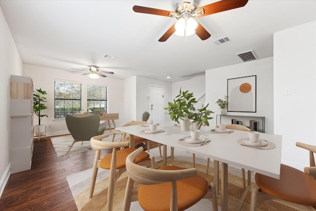 dining area featuring ceiling fan and dark hardwood / wood-style flooring