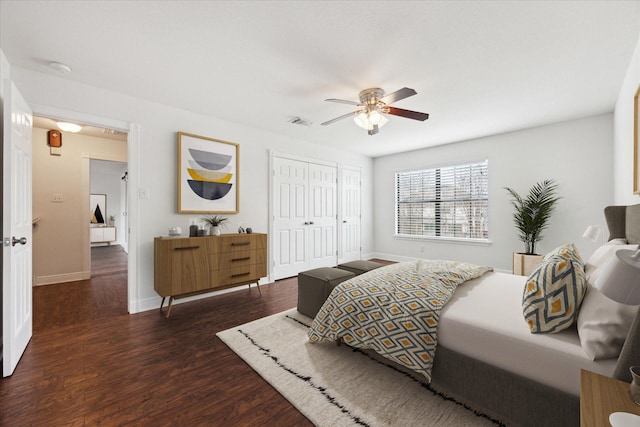 bedroom with a closet, ceiling fan, and dark hardwood / wood-style flooring