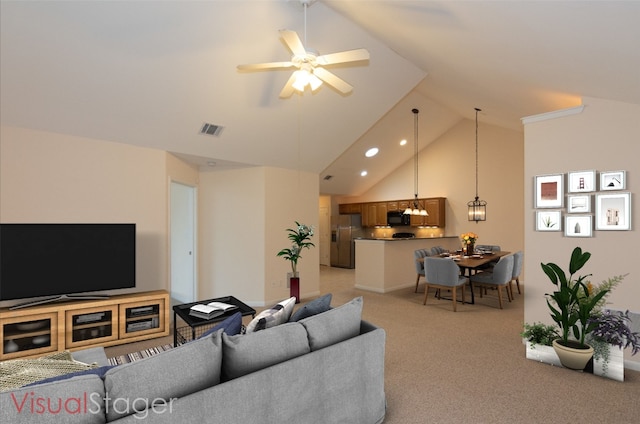 living room with ceiling fan, high vaulted ceiling, and light carpet