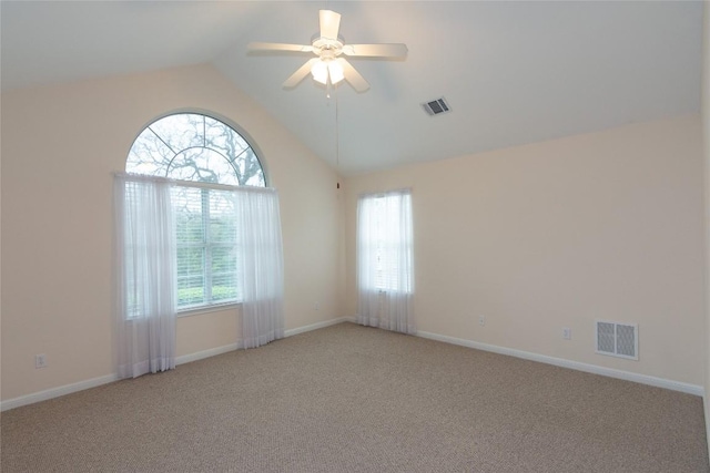 carpeted spare room with ceiling fan and lofted ceiling