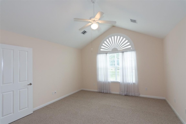 carpeted empty room featuring ceiling fan and vaulted ceiling