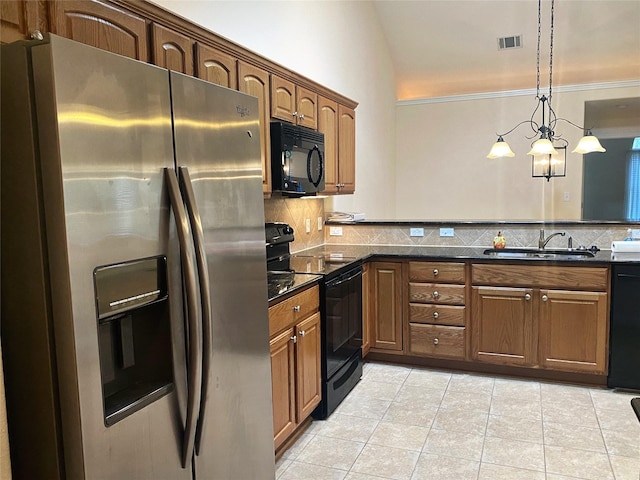 kitchen with pendant lighting, sink, backsplash, light tile patterned floors, and black appliances