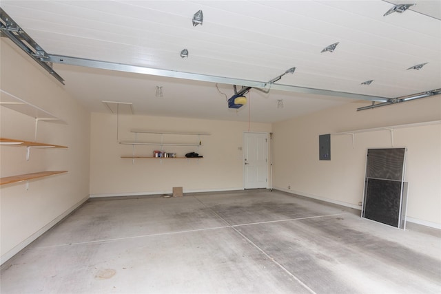 garage with a garage door opener and electric panel