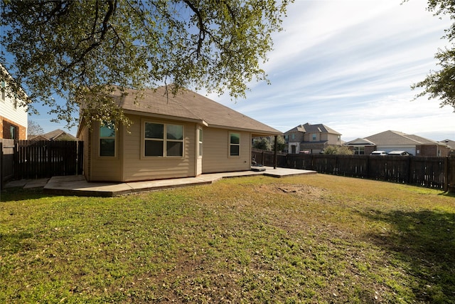 rear view of house with a patio area and a lawn