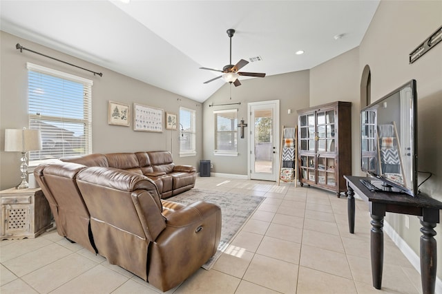 living room featuring vaulted ceiling, a wealth of natural light, ceiling fan, and light tile patterned floors