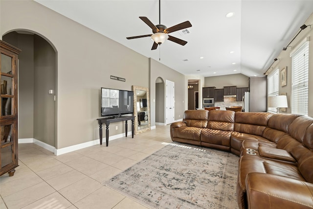 tiled living room featuring vaulted ceiling and ceiling fan