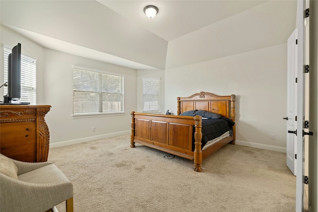 bedroom with light colored carpet and lofted ceiling