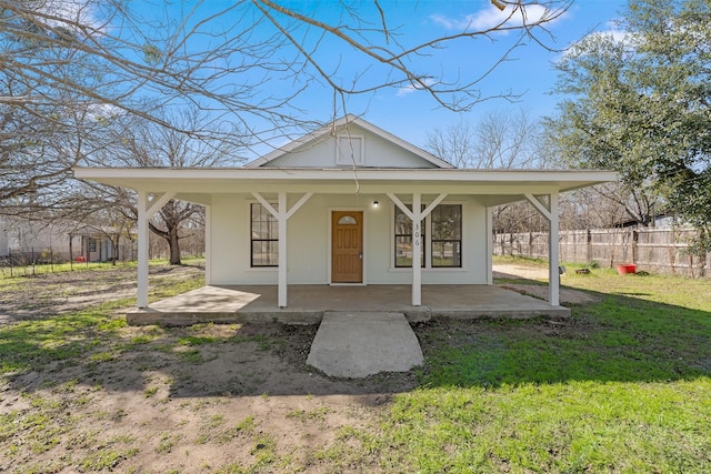 view of front of home with covered porch and a front yard