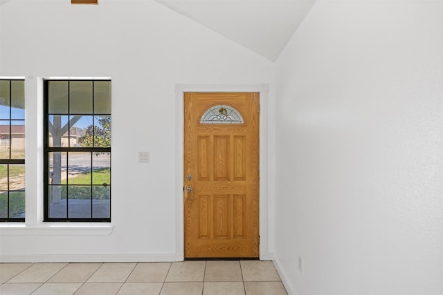 tiled foyer entrance featuring high vaulted ceiling