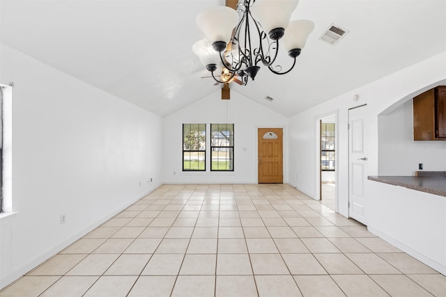 unfurnished living room with an inviting chandelier, light tile patterned floors, and lofted ceiling