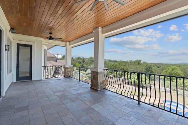 view of patio / terrace with a balcony and ceiling fan