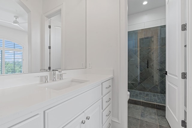 bathroom with ceiling fan, toilet, walk in shower, and vanity