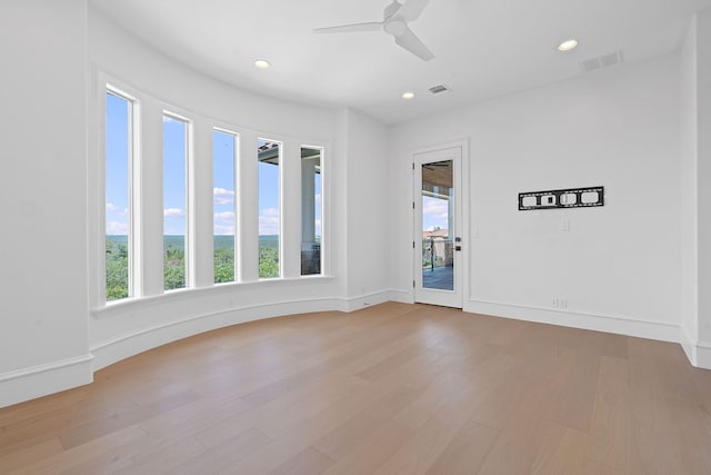 empty room featuring ceiling fan and light hardwood / wood-style flooring