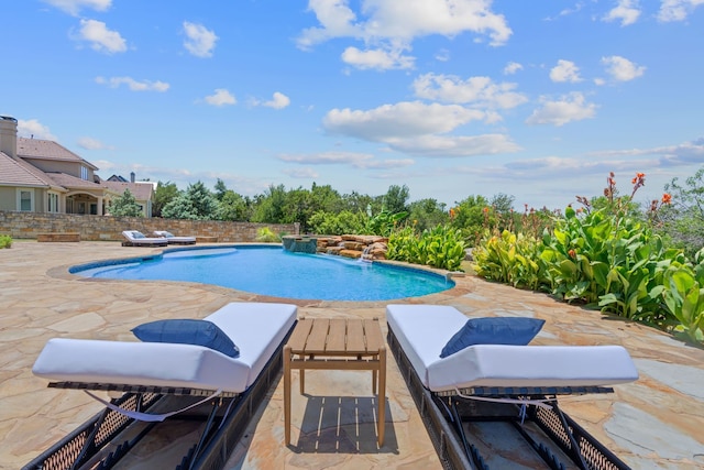 view of pool with a patio area and pool water feature