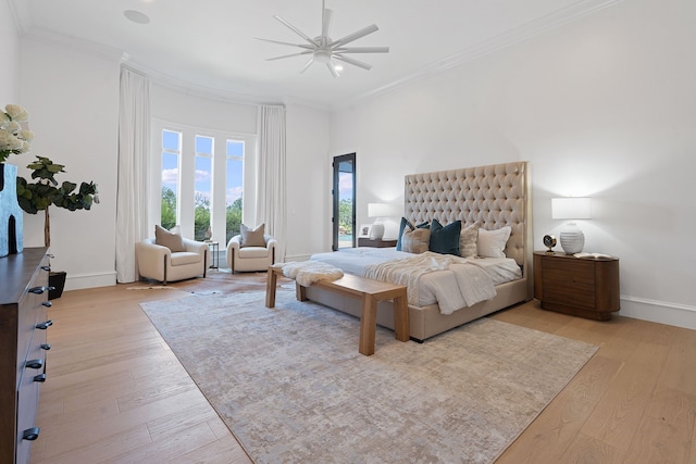 bedroom with light wood-type flooring, ceiling fan, and ornamental molding