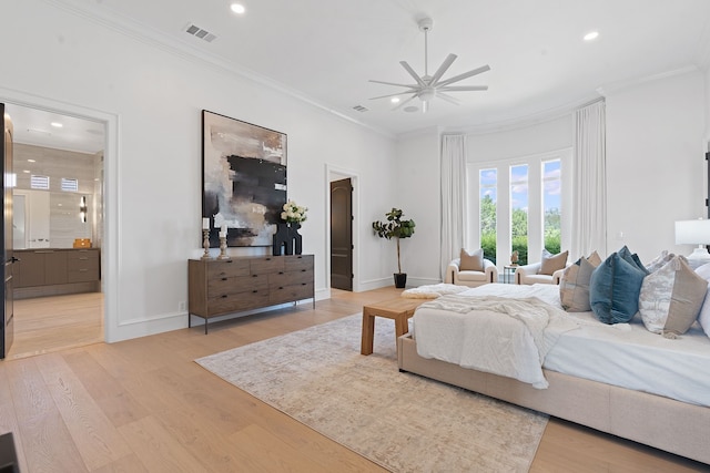 bedroom featuring ceiling fan, connected bathroom, light hardwood / wood-style flooring, and crown molding