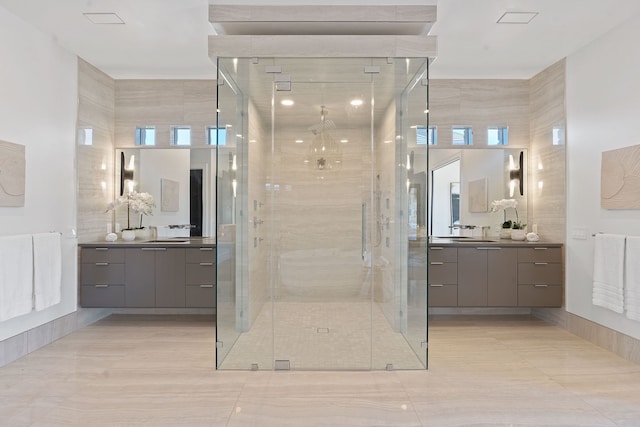 bathroom with a shower with shower door and vanity