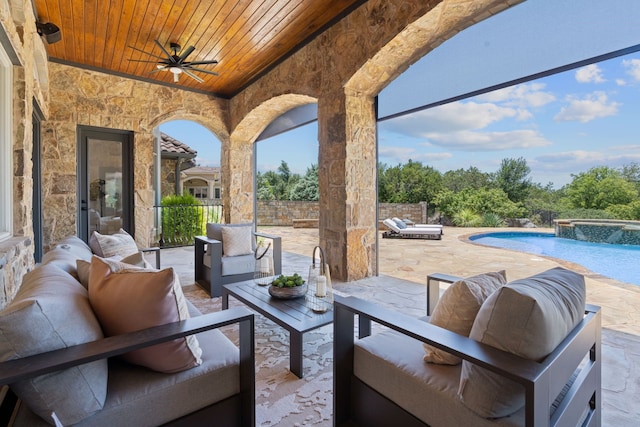 view of patio / terrace with a swimming pool with hot tub, outdoor lounge area, and ceiling fan