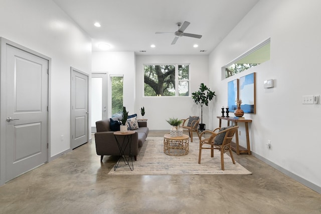 sitting room featuring a towering ceiling and ceiling fan