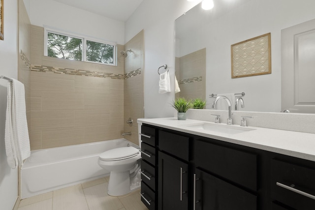 full bathroom featuring tiled shower / bath, tile patterned floors, vanity, and toilet