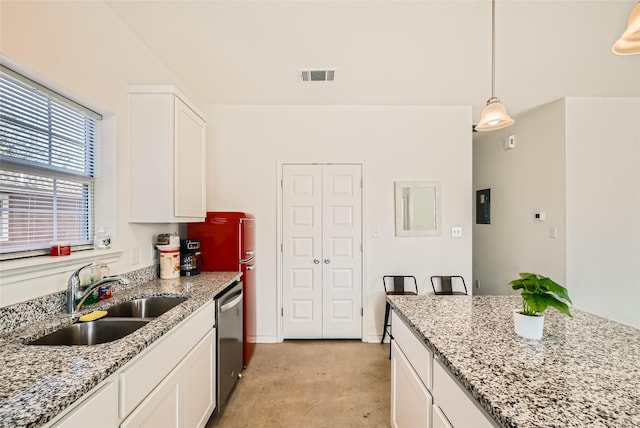 kitchen featuring pendant lighting, white cabinetry, sink, light stone counters, and stainless steel dishwasher