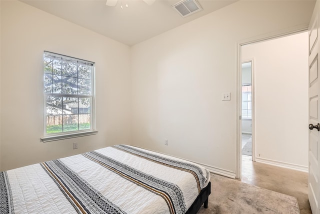 bedroom featuring ceiling fan and light carpet