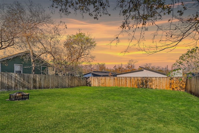 yard at dusk with an outdoor fire pit